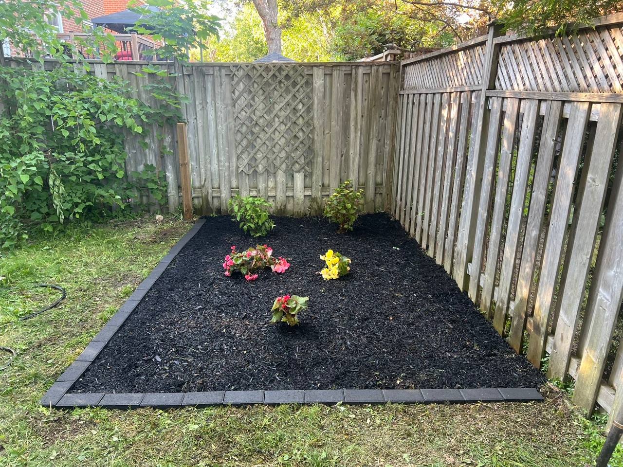Freshly mulched and planted garden bed after Summit Pine service